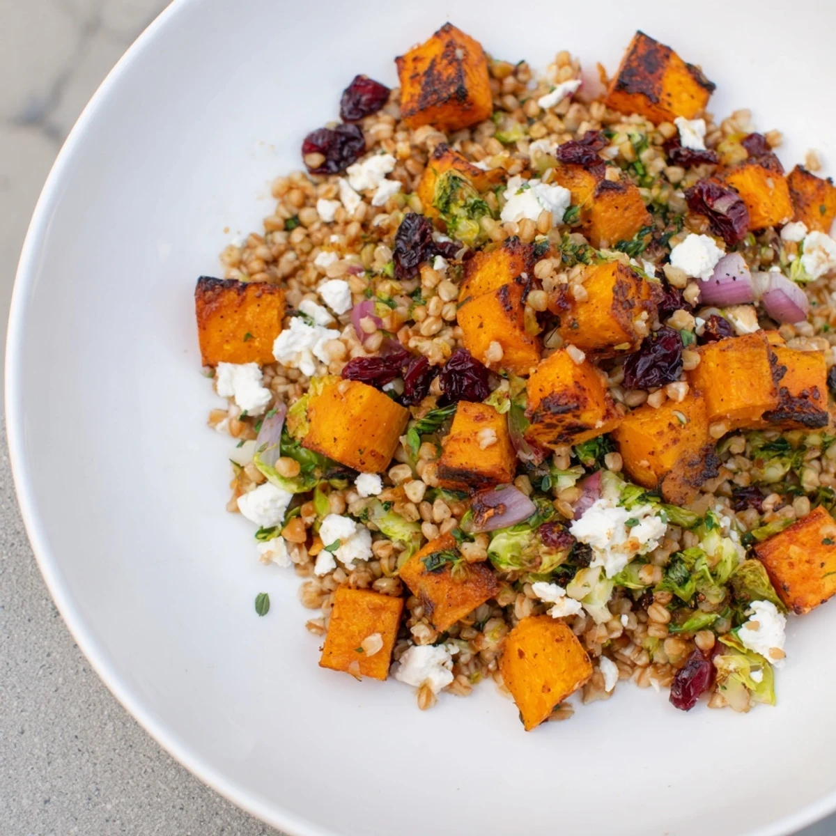 Hearty Harvest Grain Bowl includes sweet roasted pumpkin, kale, and flavorful farro for a comforting meal.
