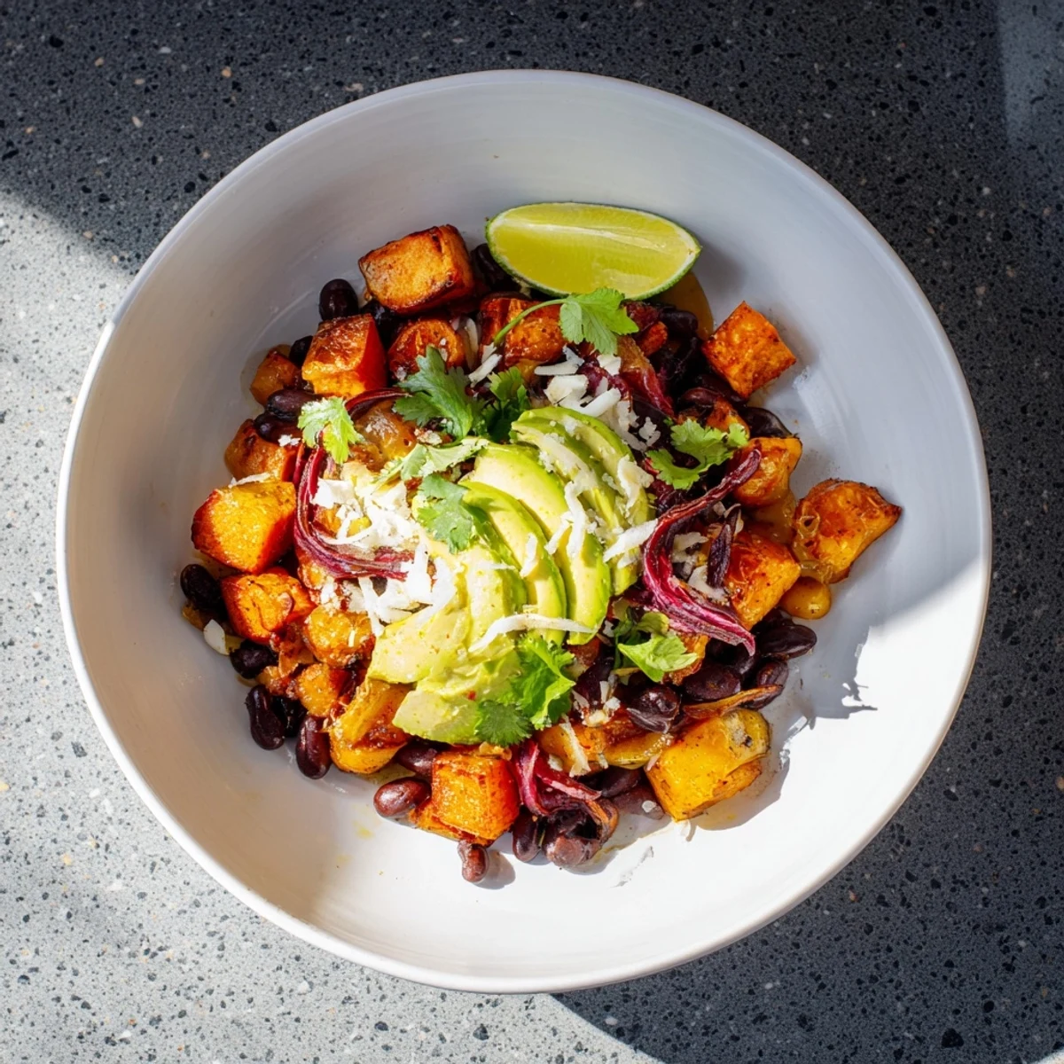 A close-up of fully assembled Quick Sweet Potato and Black Bean Tacos, appealing with fresh vegetable elements.