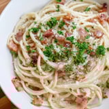 Golden, crispy bacon bits topping a steaming plate of creamy garlic bacon pasta, ready to eat.