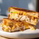Close-up of a perfectly grilled Crispy Shallot Chicken Grilled Cheese, featuring crispy shallots.