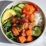 A delicious and healthy poke bowl salad featuring marinated tuna atop a bed of crisp greens.