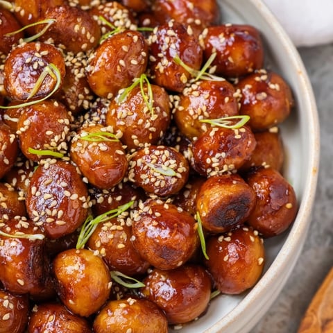 Golden-brown Crispy Honey-Soy Glazed Brussels Sprouts served on a platter, ready to enjoy as a side dish.