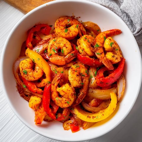 Golden brown Easy Sheet Pan Shrimp Fajitas with colorful peppers ready to serve with warm tortillas.