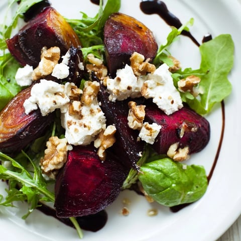 Roasted beet and goat cheese salad with vibrant red beets, creamy cheese, and a flavorful balsamic dressing.