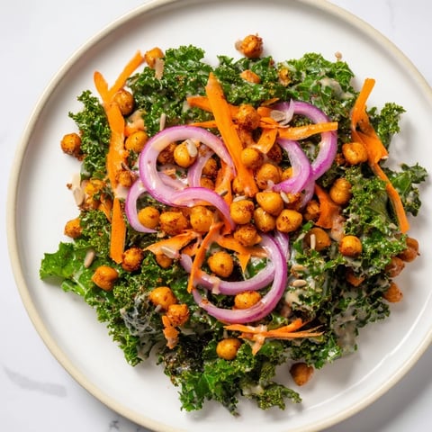 A colorful kale salad with crispy chickpeas, showcasing the roasted chickpeas' spicy aroma.