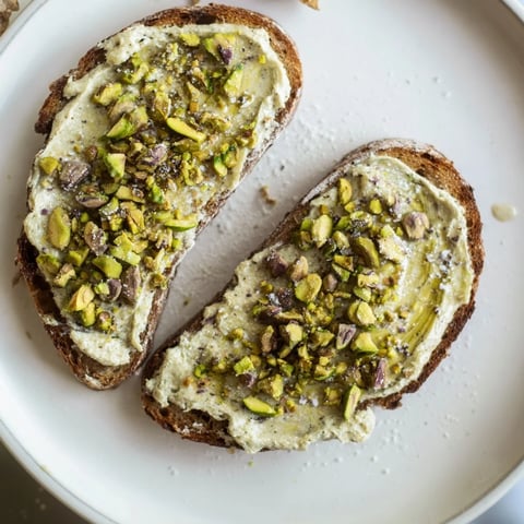 Warm, golden Pistachio Butter Toast topped with crunchy pistachios and sweet honey drizzle.