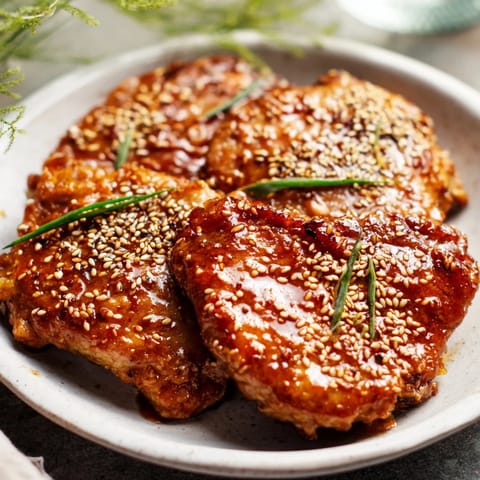 Savory and sweet, this image showcases perfectly caramelized Crispy Honey-Soy Glazed Brussels Sprouts with sesame seeds.