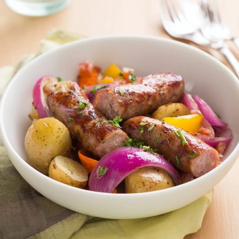 Roasted sausage, cabbage and potatoes mingle beautifully in this hearty All-in-One Pan Sausage and Cabbage Bake.