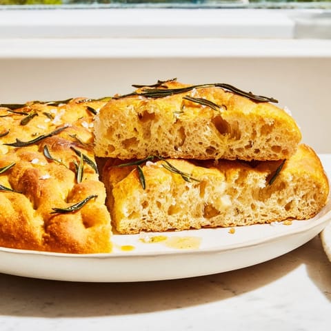 This close-up shows Simple Homemade Focaccia, a savory Italian flatbread with sea salt and herbs, ready to bake.