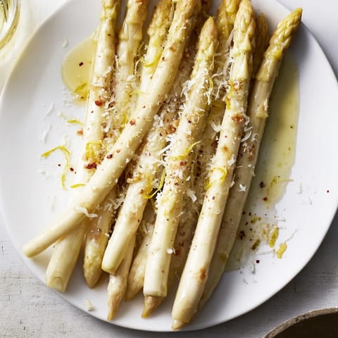 Crispy, tender Roasted Asparagus in olive oil, zesty lemon and Parmesan cheese ready to eat.