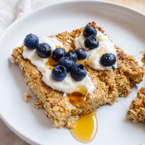 A close-up of warm, sliced Protein Pancake Oats, perfect with fresh fruit and a drizzle of syrup.