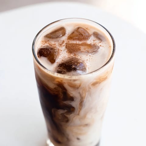A tall glass of refreshing Proffee Power Blend with ice, perfect for a high-protein breakfast.