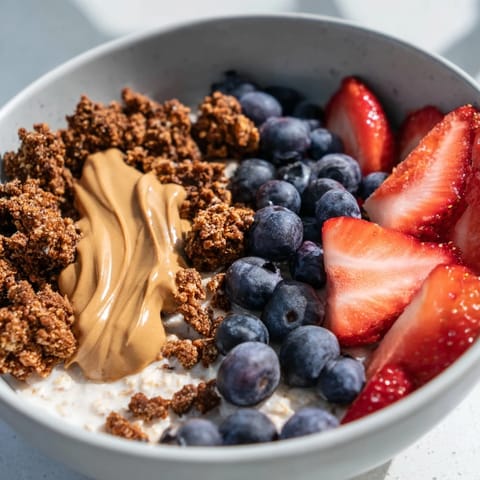 Creamy gourmet overnight oats topped with crunchy granola and a drizzle of maple syrup for breakfast.