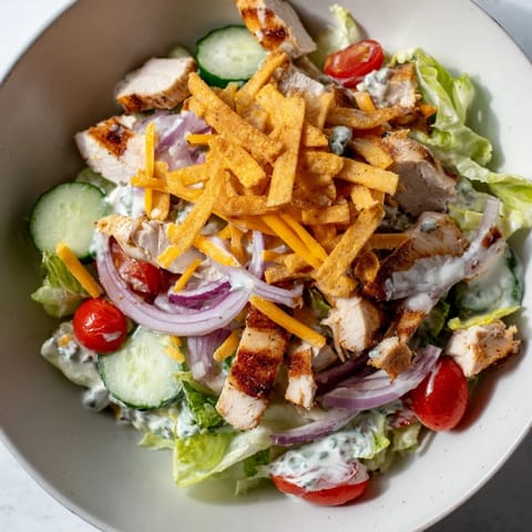 Tender grilled chicken tossed in zesty jalapeño ranch dressing, served over refreshing greens for a spicy crunch.