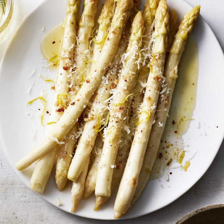Crispy, tender Roasted Asparagus in olive oil, zesty lemon and Parmesan cheese ready to eat.
