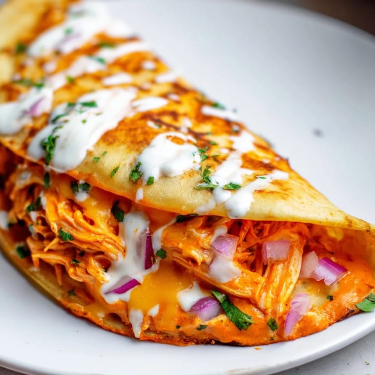 Perfectly browned Buffalo Chicken Quesadilla, featuring visible ingredients and a crispy texture, perfect for sharing.