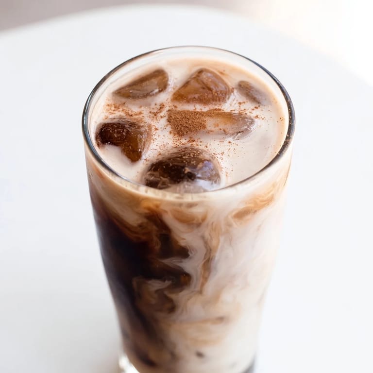 A tall glass of refreshing Proffee Power Blend with ice, perfect for a high-protein breakfast.