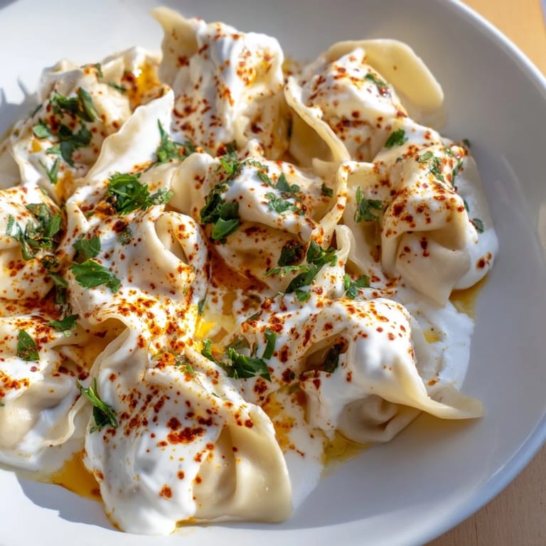 Close-up of a delightful plate of Turkish Cheesy Manti, a flavorful Turkish feast, ready to be enjoyed.