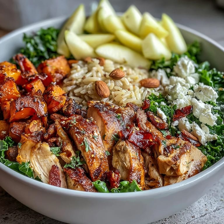Hearty Harvest Bowl ready to serve, featuring creamy goat cheese, sliced roasted chicken, and a drizzle of tangy balsamic dressing.